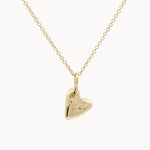Gold heart-shaped pendant on a chain against a white background