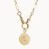 Gold chunky chain necklace with a round pendant engraved 'with love x' on a white background