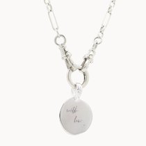 Silver chunky necklace with a round engraved pendant on a white background