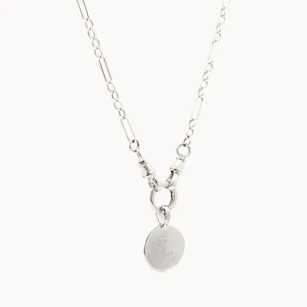 Silver chunky necklace with an handwriting engraved pendant on a white background