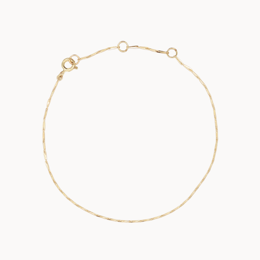 Gold hayseed bracelet on a white background