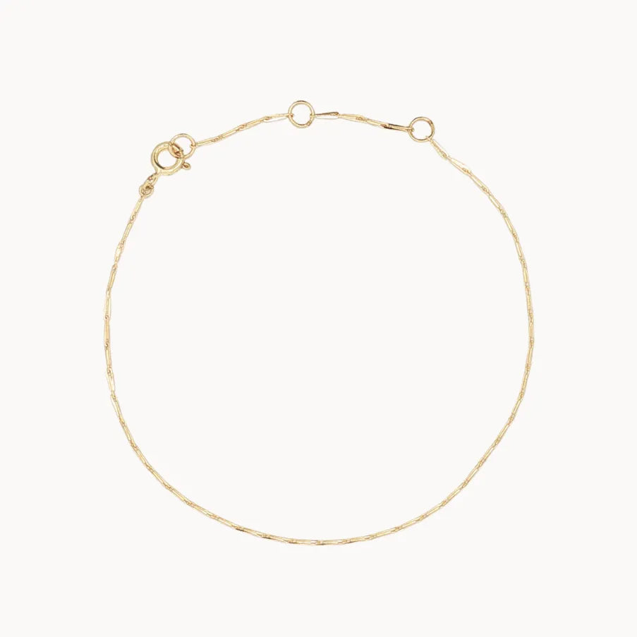 Gold hayseed bracelet on a white background