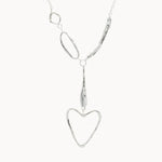 Silver necklace with a heart-shaped pendant on a white background