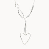 Silver necklace with a heart-shaped pendant on a white background
