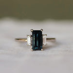 Ring with a dark gemstone on a textured surface