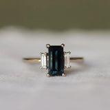 Ring with a dark gemstone on a textured surface