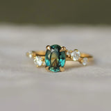 oval sapphire engagement ring with scattered diamonds in a wave formation
