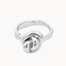 A sterling silver ring featuring a knotted design on a smooth, polished band, set against a plain off-white background.