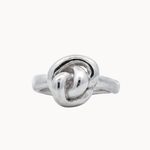 sculptural silver ring with knot design on a white background