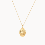 Gold leo necklace with an oval pendant on a white background
