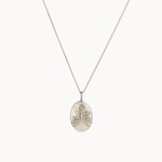 Silver libra necklace with an oval pendant on a white background