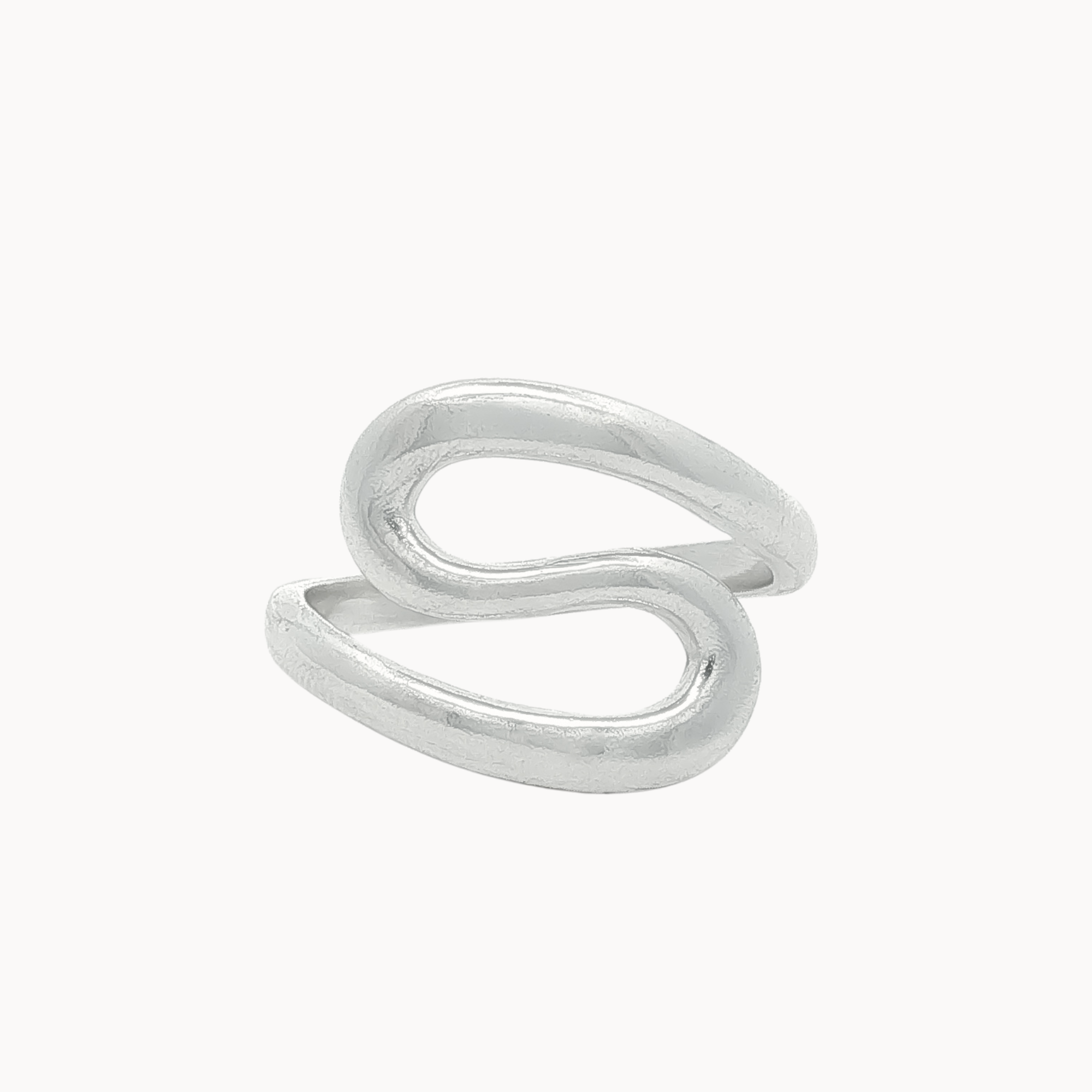 A minimalist silver ring with an organic, flowing S-shaped curve, photographed on a clean, solid off-white background.
