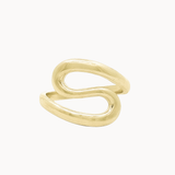 A gold s-shaped ring with a smooth, polished finish, shown on a clean off-white background.