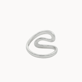 Back view of a minimalist silver open ring with a wavy, flowing S-shaped design, photographed on a clean, solid off-white background.