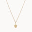 Gold necklace with a small acorn pendant on a white background
