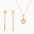 Gold jewelry set with gold diamond drop earrings and a diamond pendant necklace on a white background