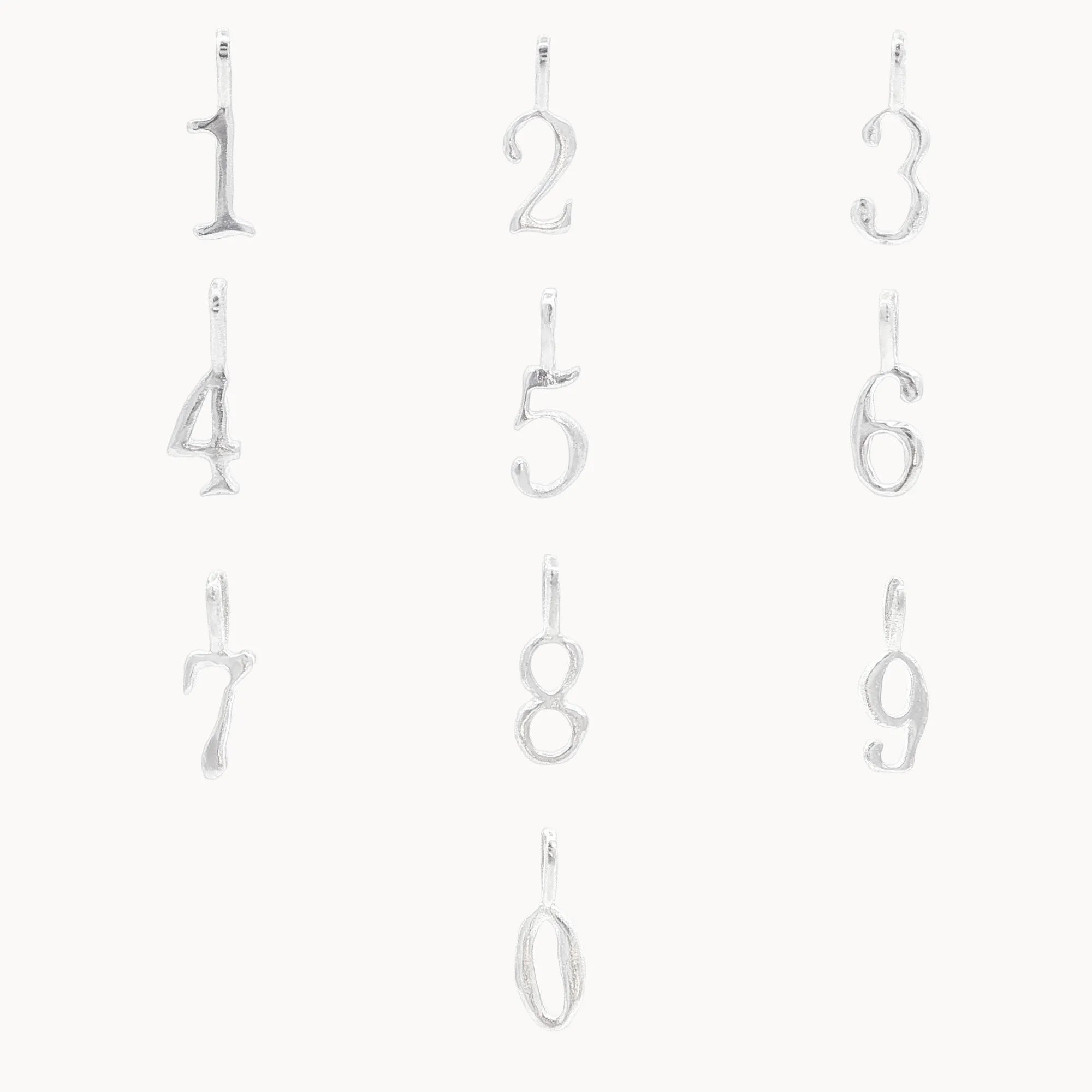 Set of silver number pendants from 0-9 on a white background