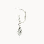 Silver hoop earring with a small dangling silver oak charm on a white background