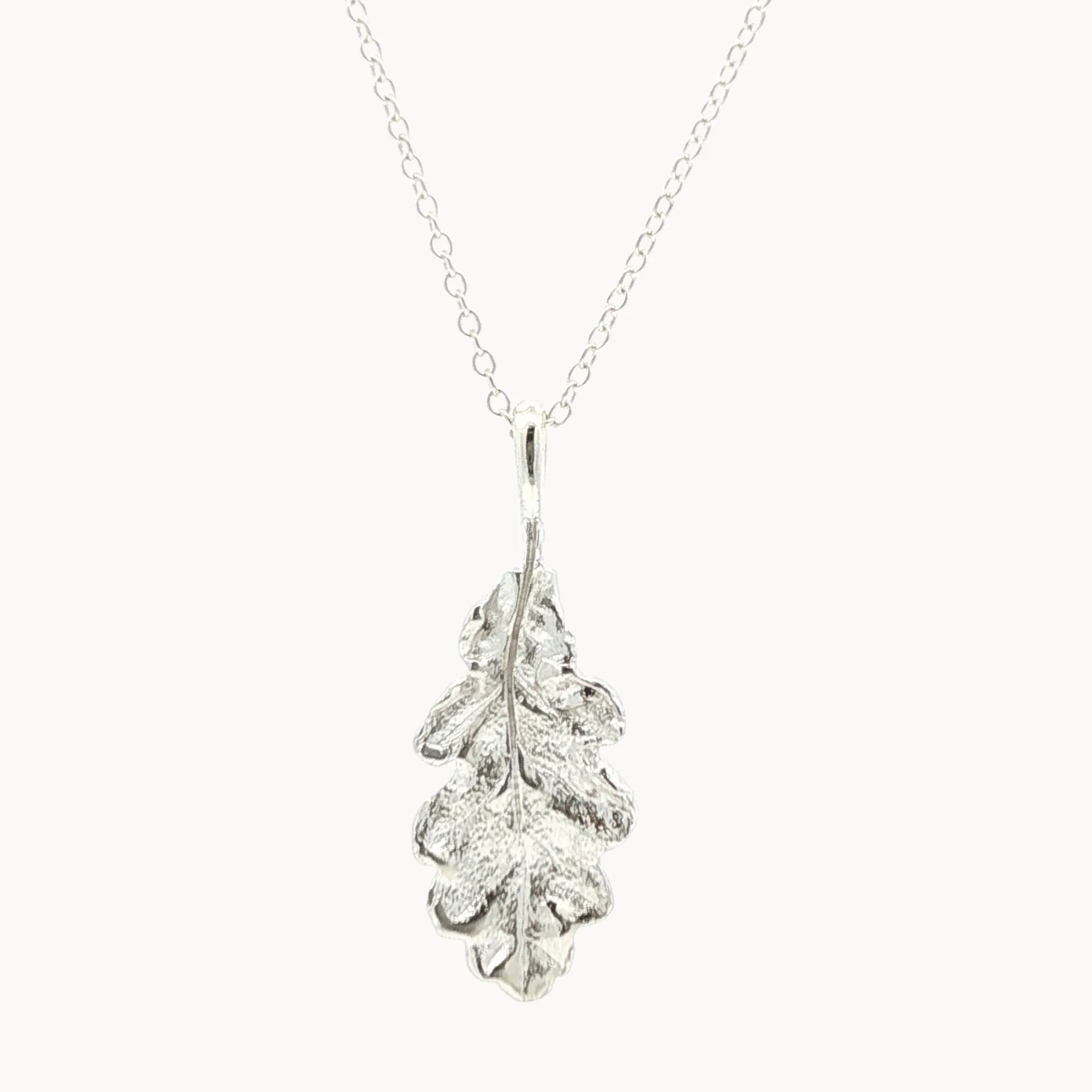 Silver oak leaf pendant necklace on a white background