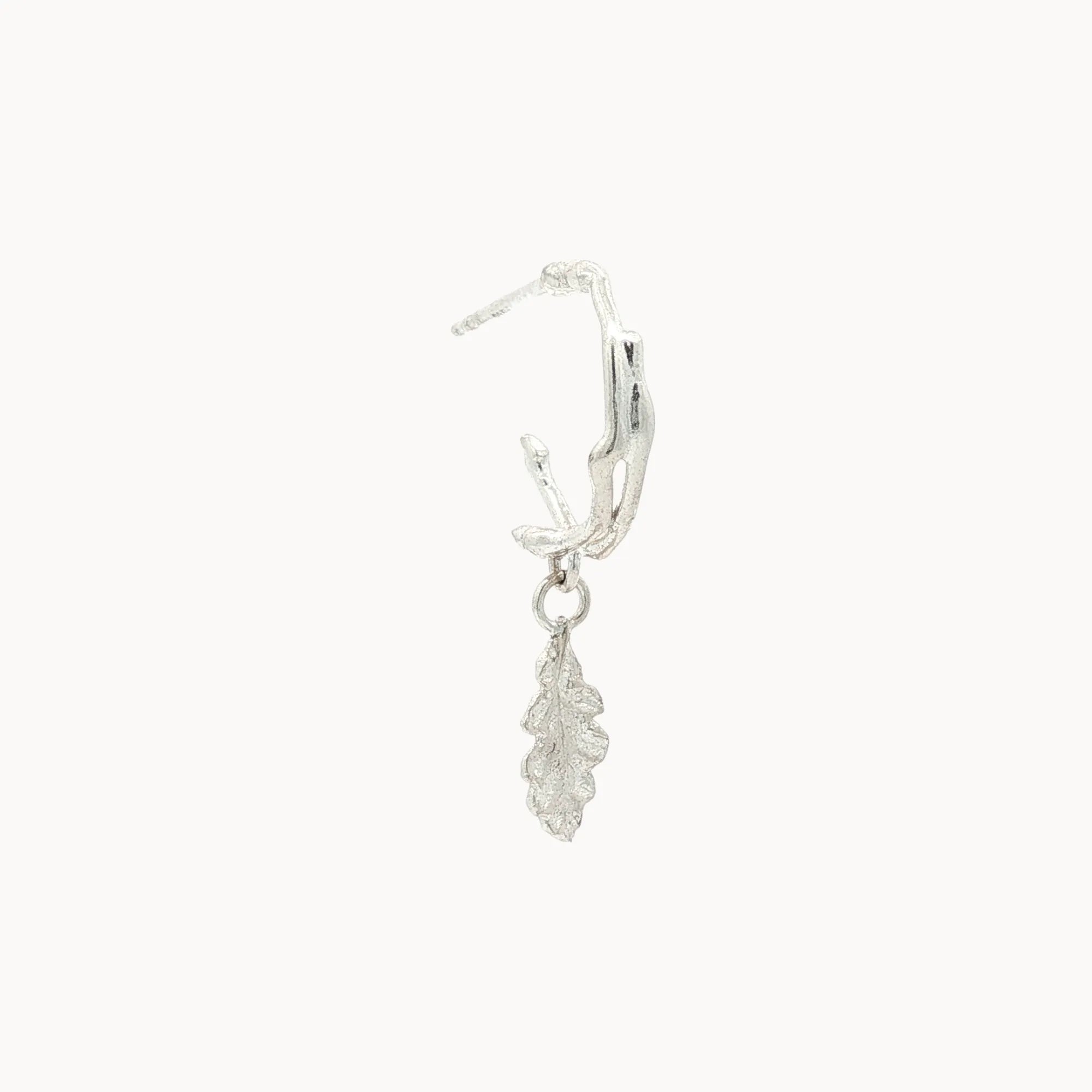 Silver leaf-shaped earring on a white background