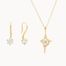 gold hook earrings and open star pendant necklace with round diamonds against a white background