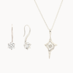 silver-toned white gold jewelry set with an open star diamond necklace and diamond hook earrings on a white background