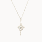 white gold four-pointed star pendant necklace with a round diamond in the middle on a white background