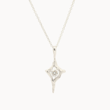 white gold four-pointed star pendant necklace with a round diamond in the middle on a white background