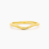 yellow gold wedding ring with soft curve shape at front and organic rustic texture on a white background low view