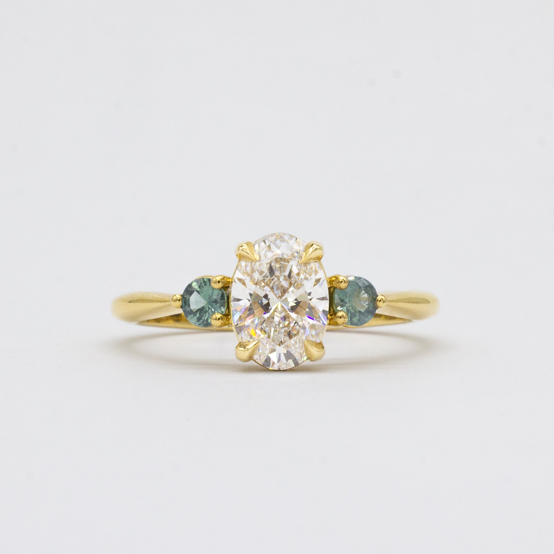 Oval Diamond and Green Tourmaline Trilogy Engagement Ring