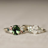 Two rings with gemstones on a textured surface