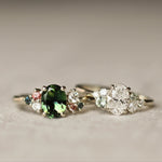 Two rings with gemstones on a textured surface