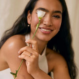 Woman holding a white rose with a soft background