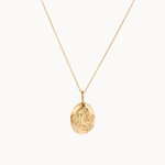 gold scorpio necklace with oval pendant on a white background