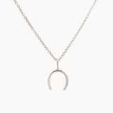 Silver horseshoe pendant necklace on a white background