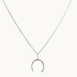 Silver wishbone horseshoe pendant necklace on a white background