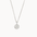 Silver necklace with a round moon and stars pendant on a white background