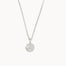 Silver necklace with a round moon and stars pendant on a white background