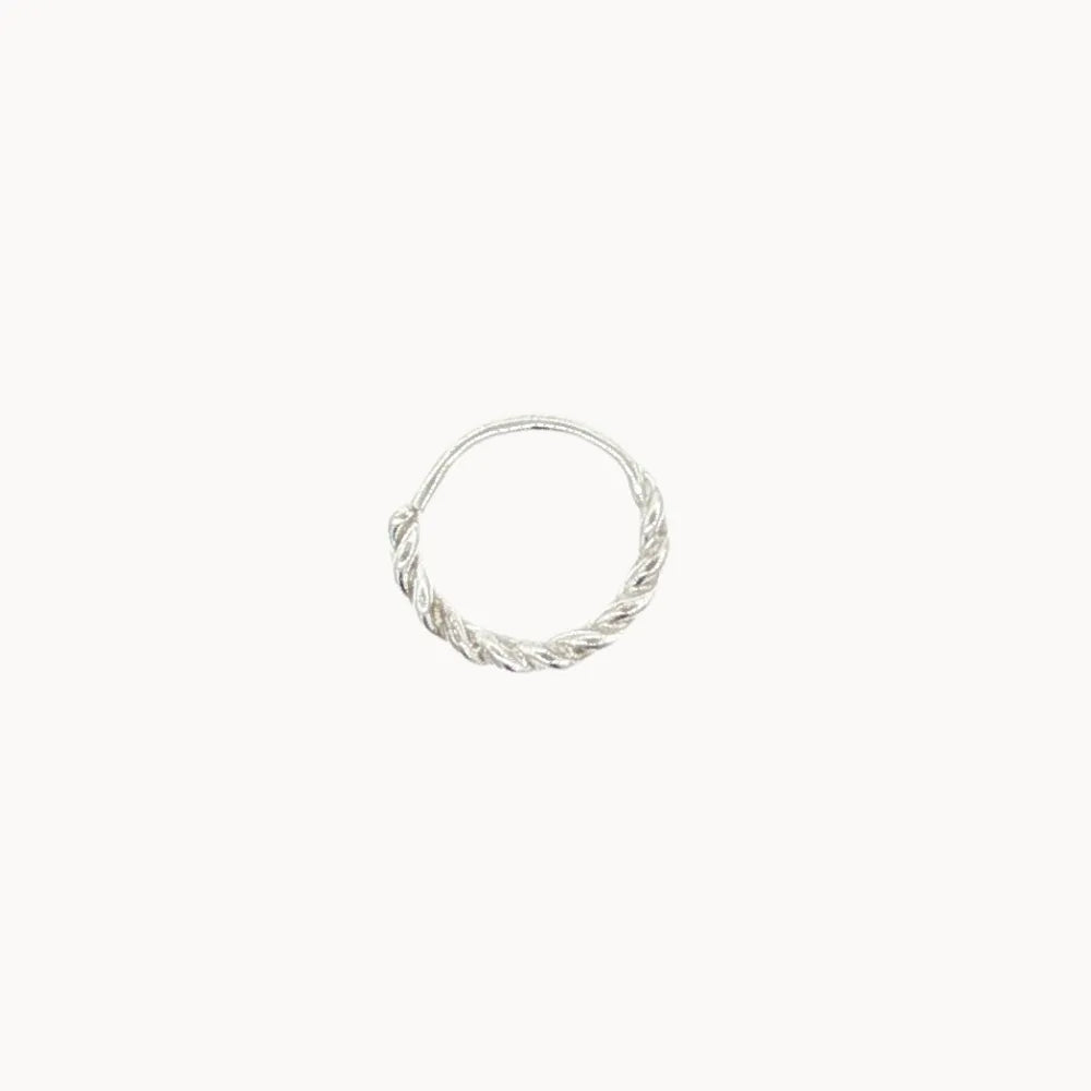 Silver helix hoop earring with a twisted design on a white background