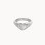 A textured silver ring with a heart-shaped face, photographed on a clean, solid off-white background.