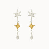 dangle earrings with silver and gold star shaped pendants on a white background