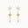 dangle mixed metal earrings with silver and gold star shaped pendants on a white background
