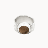 A textured silver ring with a central round smoky quartz brown stone, photographed on a clean off-white background.