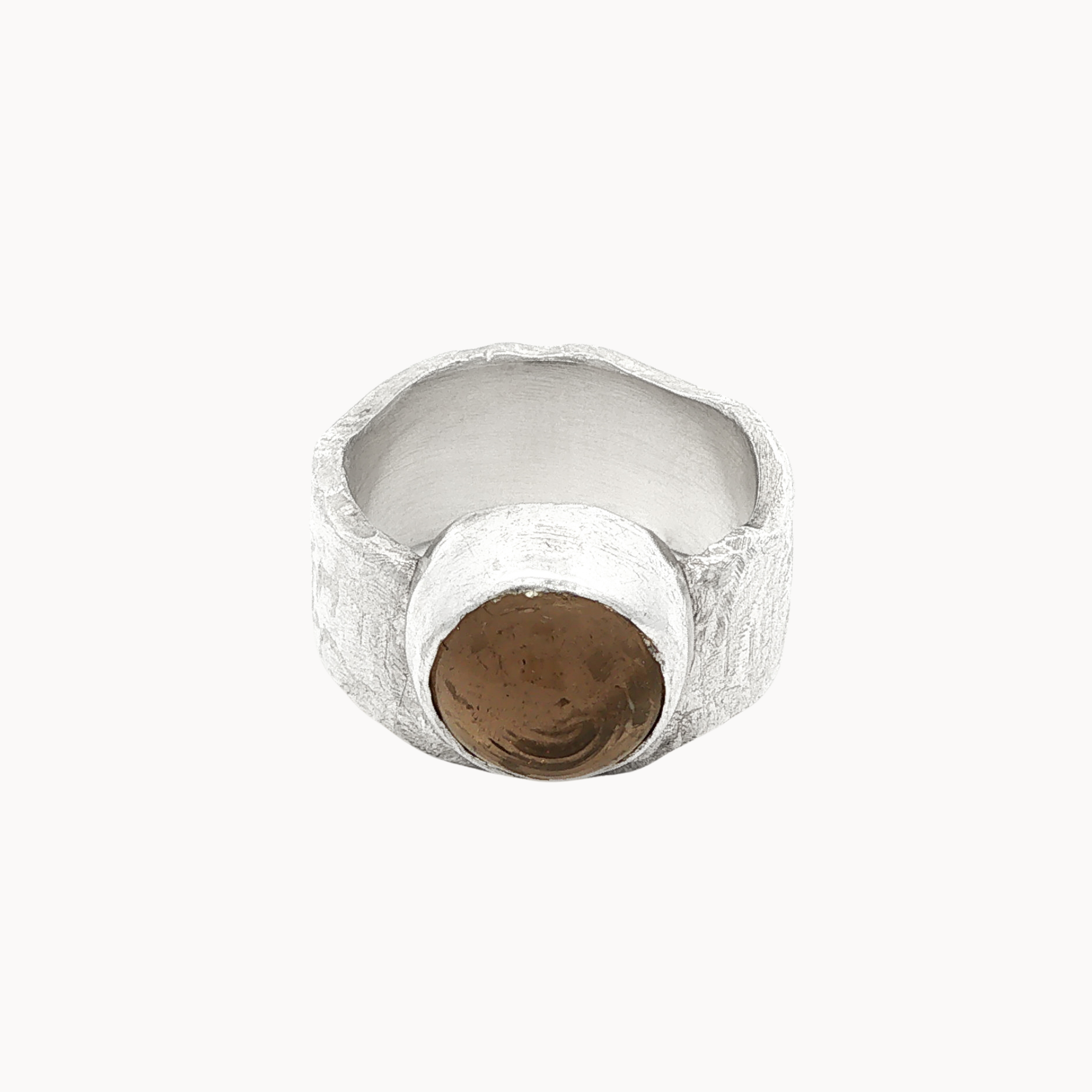 A textured silver ring with a central round smoky quartz brown stone, photographed on a clean off-white background.