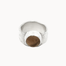 A textured silver ring with a central round smoky quartz brown stone, photographed on a clean off-white background.