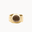 A textured gold signet-style ring with a large, smooth, round brown stone, photographed against a solid off-white background.