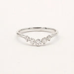 9ct white gold ring with curved diamonds on a light gray background