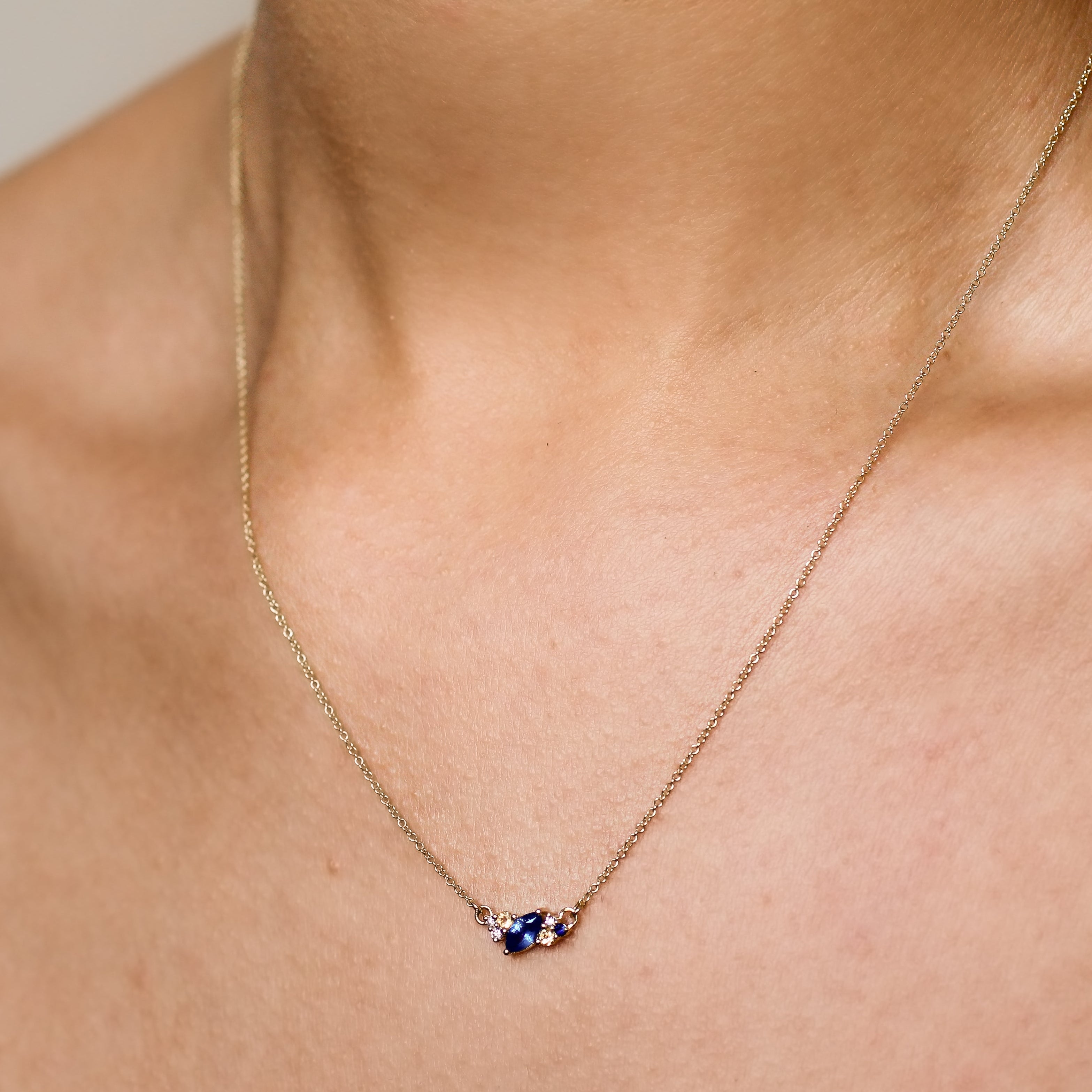 blue and yellow sapphire diamond necklace being worn