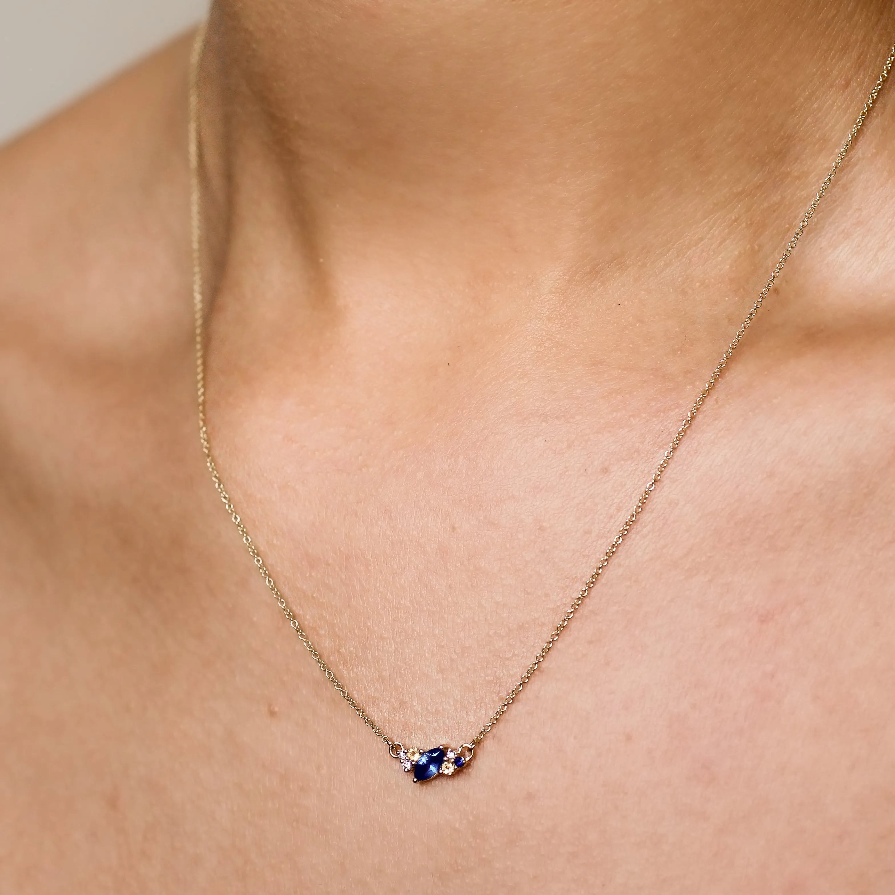 blue and yellow sapphire diamond necklace being worn