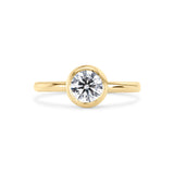 bezel set round diamond engagement ring with gold band on a white background